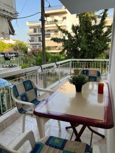 a patio with a table and chairs on a balcony at Sunny Peraia Apartment in Perea +3 photos