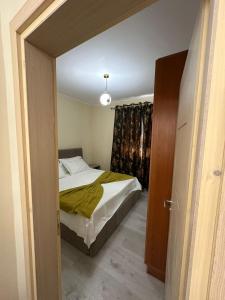 a small bedroom with a bed and a window at holiday house in Durrës