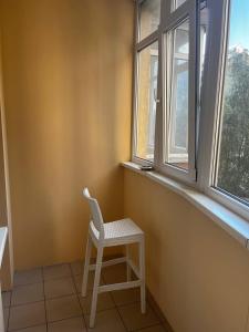 a chair sitting in front of a window at 118 apartments in Kyiv
