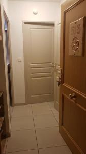 a hallway with a door and a tile floor at Les Orres 1800 - Appartement 5 pers - piscine, sauna et parking privé in Les Orres +31 photos