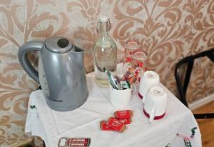 a table with a tea kettle and toothbrushes and a bottle at Drumhirk House in Newtownards