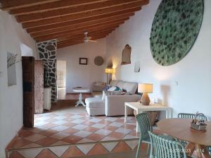 a living room with a couch and a table at Casa rural con piscina in Torre de Benagalbón