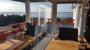 a balcony with a table and chairs and the ocean at LITTLE SKYSUITE Terrassenhaus W 94 in Cuxhaven