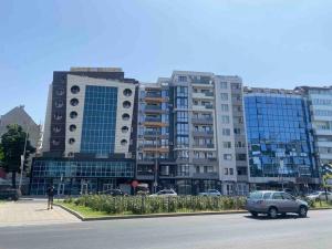 a car parked in front of a large building at Cozy-1BD Flat in Plovdiv