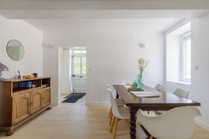a dining room with a wooden table and chairs at La Maison Coublandine in Coublanc