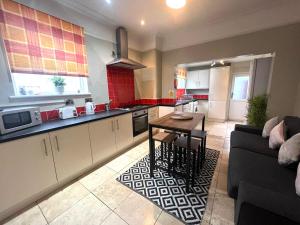 a kitchen with a couch and a table in a room at Russell House in Liverpool