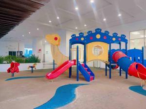 a play room with a slide and a playground at Big Happy Family @ Sri Petaling/Axiata Stadium in Kuala Lumpur