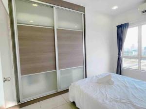 a bedroom with a bed and a large glass closet at Big Happy Family @ Sri Petaling/Axiata Stadium in Kuala Lumpur
