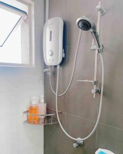 a shower in a bathroom with a shower head at Big Happy Family @ Sri Petaling/Axiata Stadium in Kuala Lumpur