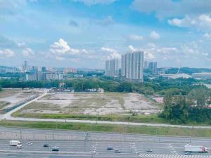 an empty parking lot with a city in the background at Big Happy Family @ Sri Petaling/Axiata Stadium in Kuala Lumpur