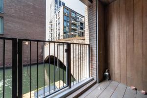 a balcony with a view of a body of water at Stylish 2-BR ground floor apt in Chelsea in London