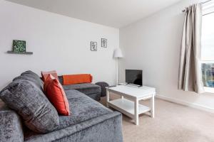 a living room with a couch and a table at Walker Suite No52 - Donnini Apartments in Kilmarnock