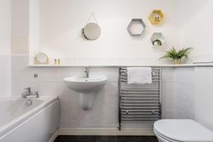 a white bathroom with a sink and a toilet at Walker Suite No52 - Donnini Apartments in Kilmarnock