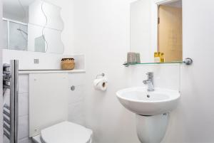 a white bathroom with a sink and a toilet at Walker Suite No54 - Donnini Apartments in Kilmarnock