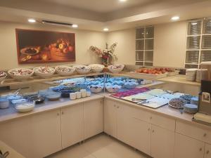 a buffet line with bowls and plates of food at Hotel Süreyya in Istanbul