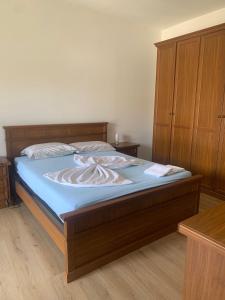 - une chambre avec un grand lit et une tête de lit en bois dans l'établissement Il BORGHETTO-1, à Grazzano Badoglio