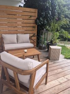 a wooden deck with a couch and a coffee table at Wohnung mit Terrasse und eigenem Parkplatz in Nabburg