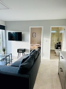 a living room with a blue couch and a kitchen at Star Scape in Markinch