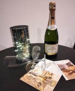 a bottle of wine on a table with a glass at LoVe & ReLaX in Épernay