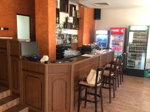 a bar in a restaurant with chairs around it at Kris Hotel & Restaurant in Smolyan