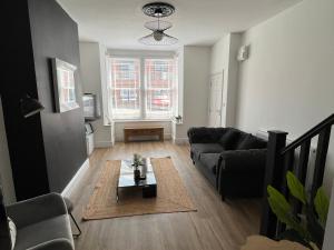 a living room with a couch and a table at Modern 2 bedroom beach house in Cleethorpes