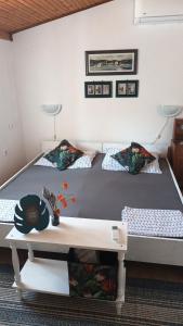a bedroom with a large bed with a table at Nona Ružica in Vis