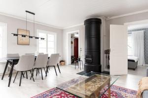 a living room with a table and a fireplace at Idyllic house in Old Rauma in Rauma