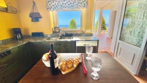 a kitchen with a table with a bottle of wine and glasses at Villa Fabiola at Home in Málaga