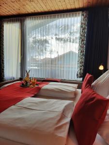 a bedroom with two beds and a table with a rabbit sitting on top at Hotel Bella in Obertauern