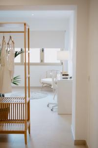 a white room with a dressing room with a dressing table at Las Canteras Beach Suites in Las Palmas de Gran Canaria +185 photos