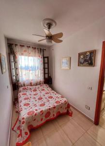 a bedroom with a bed and a ceiling fan at Puertito Varadero in Puerto de Santiago