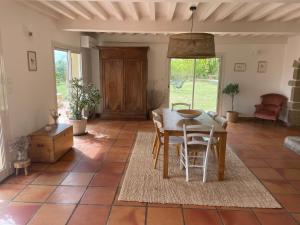 a dining room with a table and chairs at La Sauveterre in Mours-Saint-EusÃ¨be