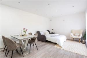 a bedroom with a bed and a table and chairs at Guest house in Dublin in Cluain Aodha