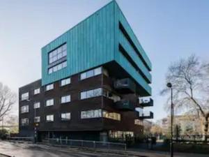 a large building with a green roof at Pass the Keys Boutique London Flat near Tower Bridge and Tube in London