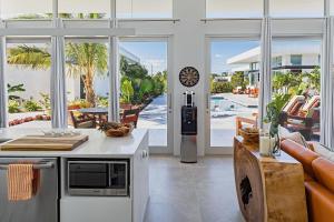 A kitchen or kitchenette at White Villas - Romantic Getaway - Oceanside Large Modern Studio with Pool, 500ft from Long Bay Beach