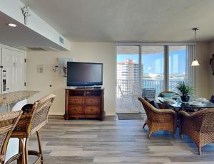 a living room with a television and a table and chairs at Lovers Key Resort 1105 - 1 Bedroom - Sleeps 4 in Fort Myers Beach