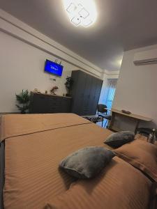 een slaapkamer met een bed met 2 kussens erop bij Divine Comfort Apartments Palas Mall in Iaşi