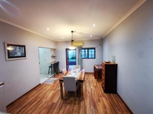 a dining room and living room with a table and chairs at Botrivier's Eden in Botrivier