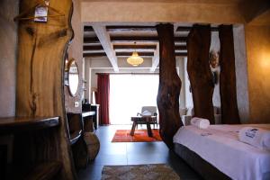 a bedroom with a bed and a room with a window at MAVİ AT HOTEL Blue Horse in Gümüşdere