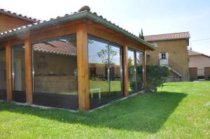 a wooden gazebo in the yard of a house at B&B La Cerisaie in Francheleins