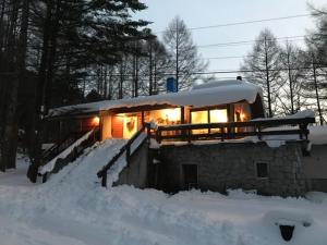 a house covered in snow with the lights on at New Togakushi Sea Hail - Vacation STAY 51752v in Nagano
