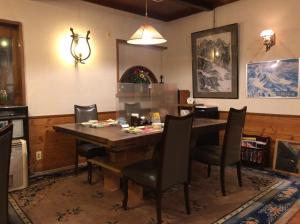 a dining room with a wooden table and chairs at New Togakushi Sea Hail - Vacation STAY 47754v in Nagano