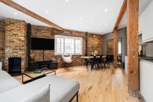 a living room with a brick wall at Newly Refurbished Warehouse Cnv 2BR Apt Bermondsey in London
