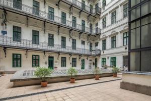 a large building with potted plants in a courtyard at Central New Cozy in Budapest