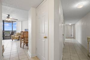 a hallway with a door leading to a dining room at Nautilus Sunset Escape 801 | Flagler Beach in Flagler Beach