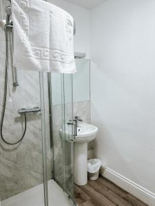 a bathroom with a shower and a sink at The Red Lion Inn in Rothwell +68 photos