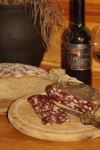 a table with bread and a bottle of wine at Guest House and Museum Firšt in Solčava