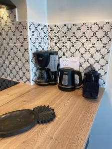 a kitchen counter with a coffee maker and a appliance at Marianne 3 in Bergerac
