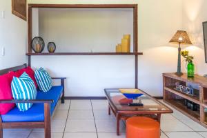 a living room with a blue couch and a table at Pousada dos Coqueiros Búzios in Búzios +141 photos