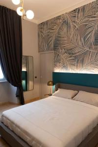 a bedroom with a large white bed with a wall at Spazio SIMA Space 2 - 2 in Milan
